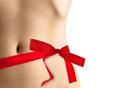 Womans perfect waistline wrapped with a beautiful red ribbon lik