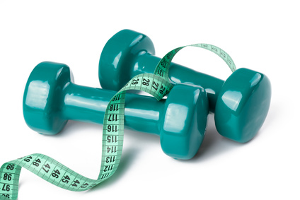 green dumbell with measuring tape
